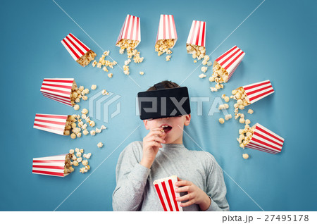 Child lying on blue background in Virtual reality Child lying on blue background in Virtual reality 27495178