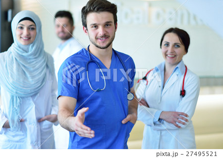 friendly male doctor with open hand ready for friendly male doctor with open hand ready for 27495521