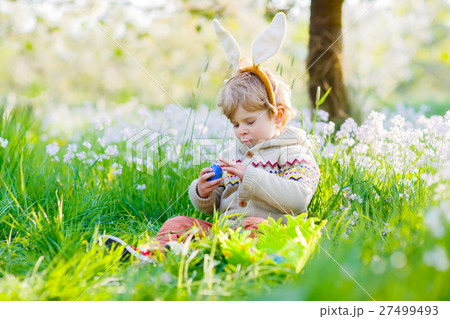 little kid boy having fun with traditional Easter little kid boy having fun with traditional Easter 27499493