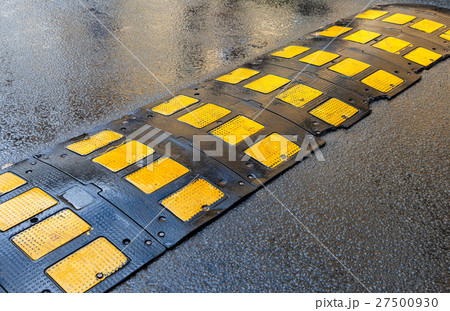 Traffic safety speed bump on an asphalt road 27500930
