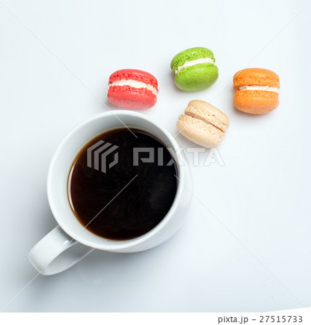 Sweet and colourful macaroons with cup of coffee Sweet and colourful macaroons with cup of coffee 27515733