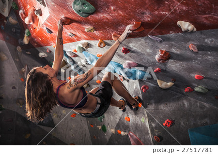 woman training on practice climbing wall indoor woman training on practice climbing wall indoor 27517781