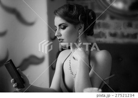 Retro image. The girl looks in the mirror Retro image. The girl looks in the mirror 27521234