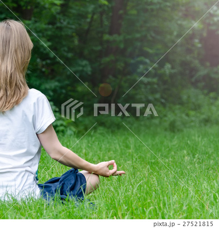 Woman doing yoga in the park Woman doing yoga in the park 27521815