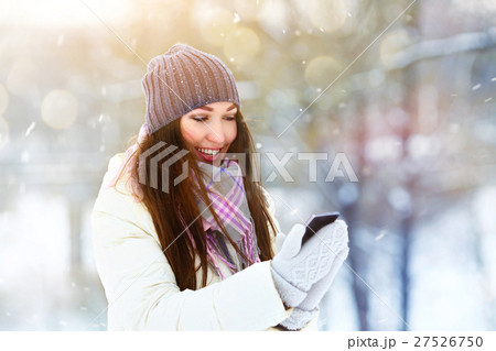 Portrait of smiling young woman talking mobile Portrait of smiling young woman talking mobile 27526750