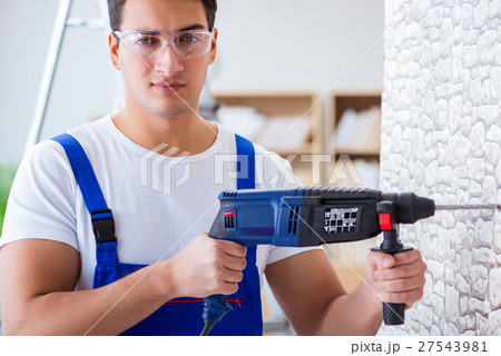 Repairman working with drilling drill perforator Repairman working with drilling drill perforator 27543981