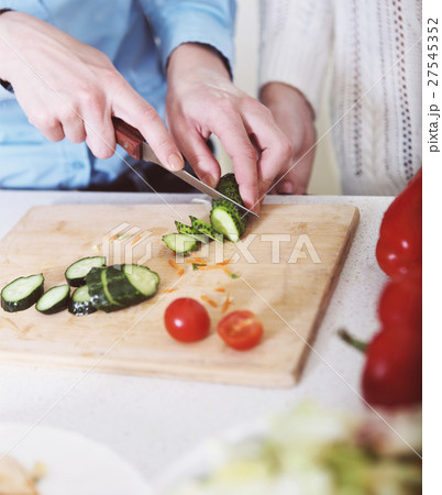 Woman cooking vegetables salad Woman cooking vegetables salad 27545352