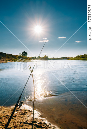 Fishing rod on the background of a river landscape Fishing rod on the background of a river landscape 27550373