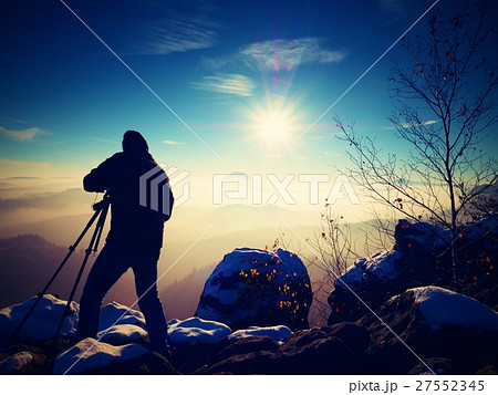 Sunny winter. Photographer with camera on tripod Sunny winter. Photographer with camera on tripod 27552345