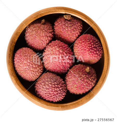 Lychee or litchi fruits in wooden bowl over white 27556567