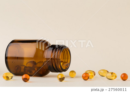 Bottle of pills from the brown glass and fish oil Bottle of pills from the brown glass and fish oil 27560011