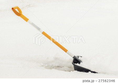 Snow shovel in snow Snow shovel in snow 27562346