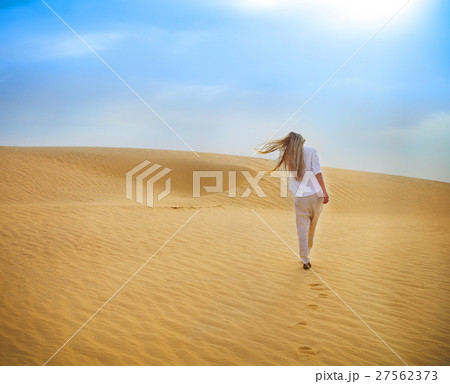 Blond woman walking in Sahara desert. Tunisia. 27562373
