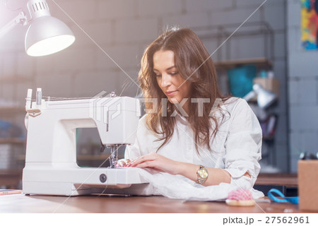 Attractive Caucasian seamstress working stitching 27562961