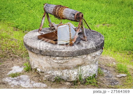 Old water well with bucket  27564369
