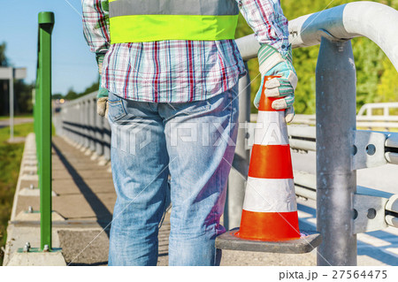 Road construction worker with traffic cone near hi Road construction worker with traffic cone near hi 27564475
