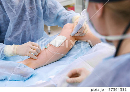 doctor and an assistant in operating room doctor and an assistant in operating room 27564551