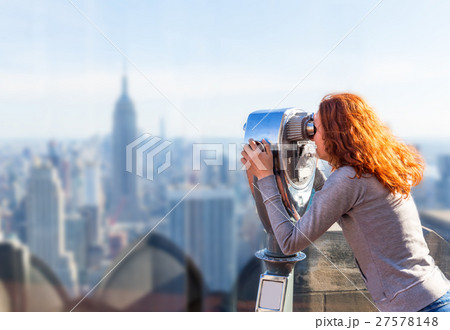 Woman looking in observation binoculars. 27578148