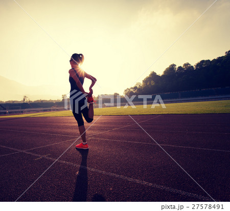 Young woman runner stretching legs Young woman runner stretching legs 27578491
