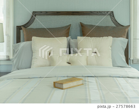 cozy bedroom with white and blue pillows on bed 27578663