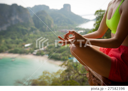 young healthy woman practice yoga on mountain peak cliff young healthy woman practice yoga on mountain peak cliff 27582396