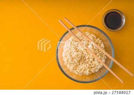 Soup Ramen noodles in glass bowl and soy sause Soup Ramen noodles in glass bowl and soy sause 27588027