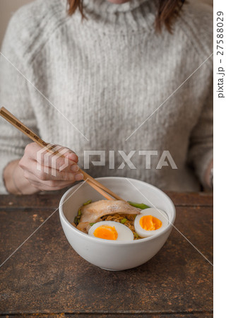 Woman eating Asian soup Ramen with chicken Woman eating Asian soup Ramen with chicken 27588029