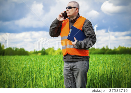 Farmer with smartphone on the green cereal field 27588716