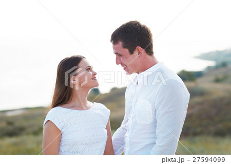 Young happy couple in love near sea in summer day 27594099