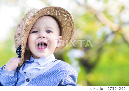 Cute happy caucasian baby boy in spring park looks Cute happy caucasian baby boy in spring park looks 27594292