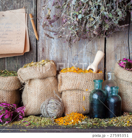 Healing herbs in hessian bags, tincture and paper  27595351