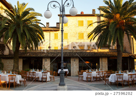 Grey lantern stands in the middle of backyard 27596202