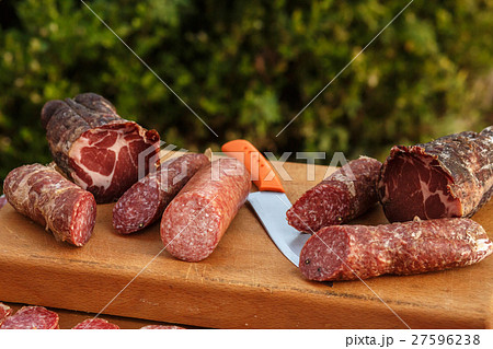Salted italian meat lies on wooden board  Salted italian meat lies on wooden board  27596238