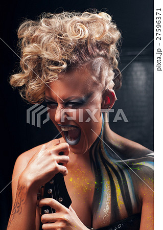 Portrait of screaming punk woman with body art 27596371