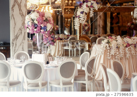 Grey chairs stand around round tables prepared  27596635