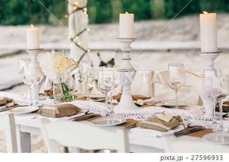 Crystal glassware and white candles stand Crystal glassware and white candles stand 27596933