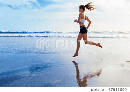 Active woman run by sunset beach. Sport background 27611890