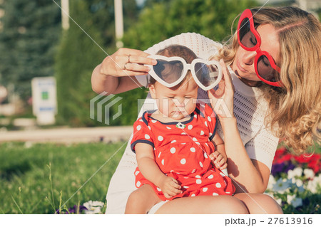 Happy mother and daughter playing in park. 27613916