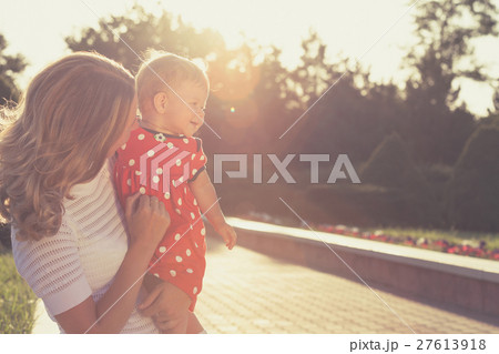 Happy mother and daughter playing in park. 27613918