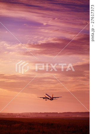 Airplane taking off at the sunset sky 27617373