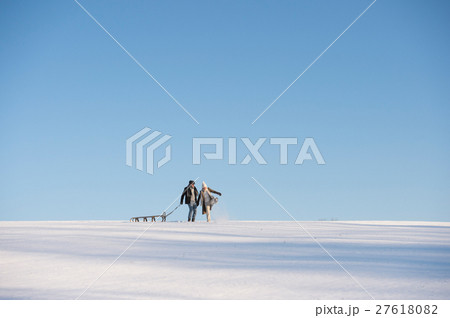 Beautiful senior couple on a walk pulling sledge Beautiful senior couple on a walk pulling sledge 27618082