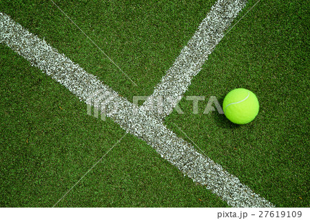tennis ball near the line on tennis grass court go 27619109