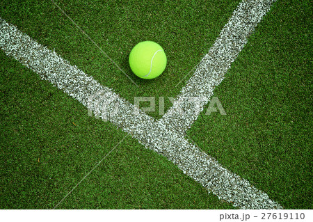 tennis ball near the line on tennis grass court go tennis ball near the line on tennis grass court go 27619110