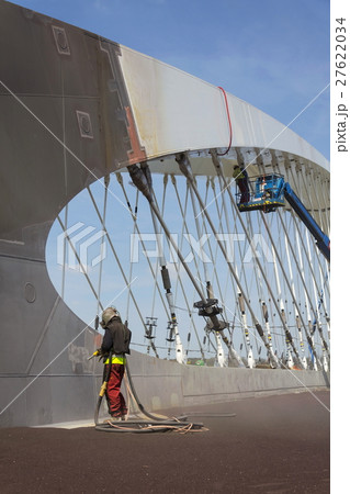 Man with helmet working on a bridge construction 27622034