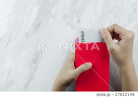 Woman hand holding money with red envelope 27622148