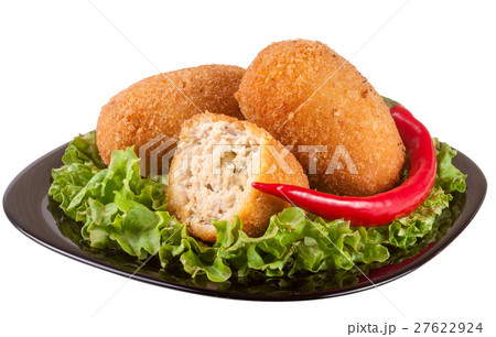 three fried breaded cutlet with lettuce on a black three fried breaded cutlet with lettuce on a black 27622924