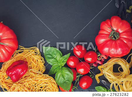 Raw pasta with ingridients on black board 27623282