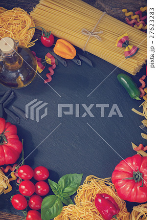 Raw pasta with ingridients on black board 27623283