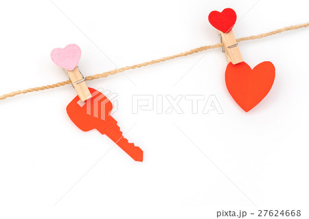 Red paper heart hanging on white background . 27624668