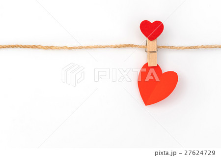 Red paper heart hanging on white background . 27624729